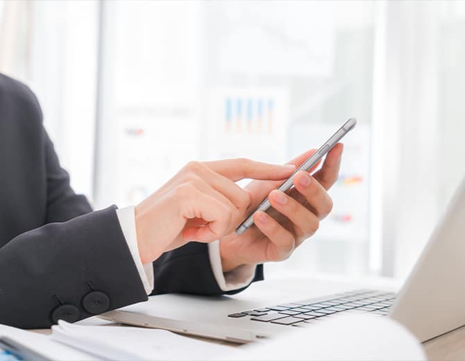 savoir member holding phone in hand